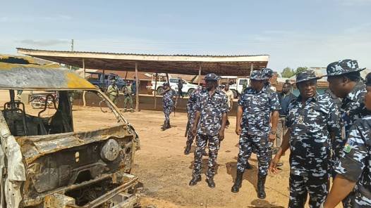 Nigerian police officers inspect a burnt vehicle involved in the Plateau mob killing incident in Mangun village, Plateau State, following a deadly mob attack on wedding-bound travellers.