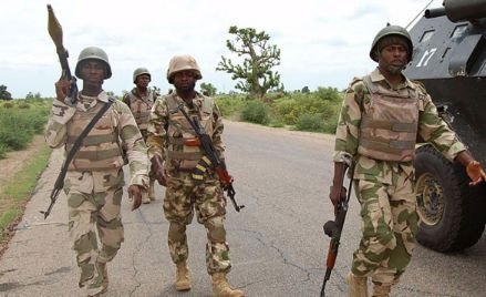 Nigerian soldiers during a security operation in a rural area, symbolizing the fight against terrorism and insecurity across Nigeria under the Tinubu administration.