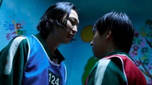 Nam-gyu confronts Min-su in a tense scene from Squid Game Season 3, symbolizing the lingering presence of Thanos.