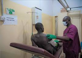Health issue in Nigeria; Nigerian healthcare workers attending to patients in a community clinic