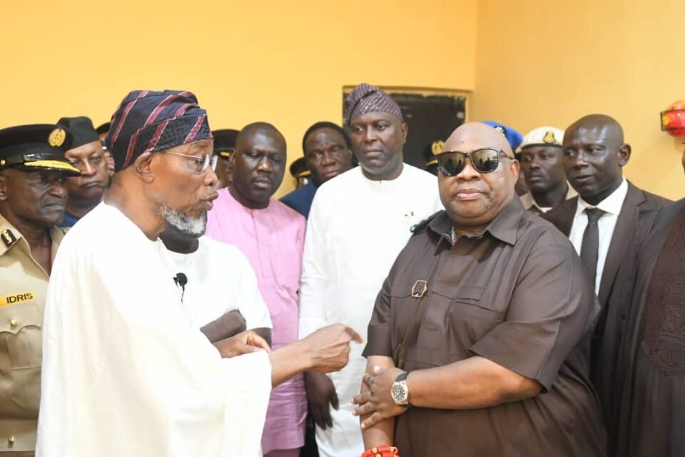 Adeleke vs Aregbesola Feud: Osun Governor Ademola Adeleke confronts former Minister Rauf Aregbesola during a public event surrounded by security officers and officials.
