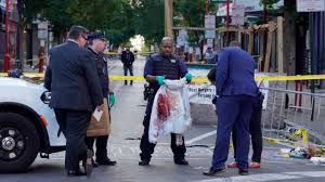 Philadelphia shooting ; Philadelphia police officers investigate crime scene after deadly mass shooting in Grays Ferry.